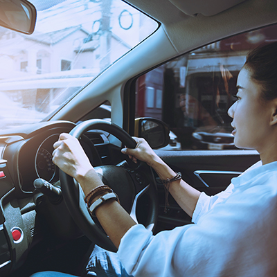 Woman hand holding the steering wheel a car. drive a car travel Safety First